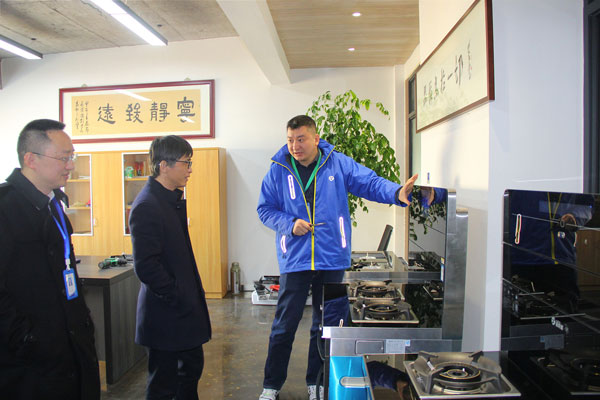 藍炬星電器副總裁王春雷為沈建新教授一行人介紹藍炬星·AIoT智能集成灶